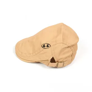 Détail de la boucle métallique réglable et des coutures sur la casquette en coton beige