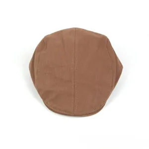 Detailed view of brown cotton linen flat cap showing textured twill fabric and stitching