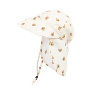 Breathable baby sun hat with neck flap and cute cartoon bear print in cream color