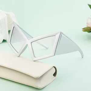 Futuristic geometric silver frame sunglasses with a folding case on a stylish background