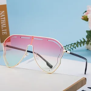 Oversized gradient sunglasses with gold metal frame and modern rimless design for women