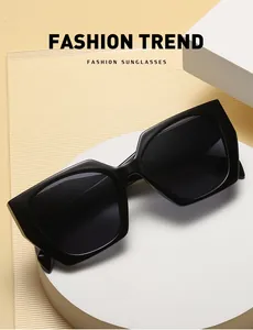 Detail view of stylish black cat eye sunglasses with thick temples on a white pedestal