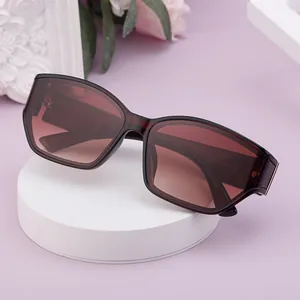 Deep red polarized sunglasses for women with gold metal temples and gradient brown lenses
