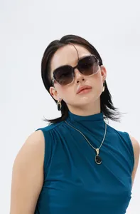 Close-up of trendy square polarized sunglasses with elegant jewelry on a fashion model