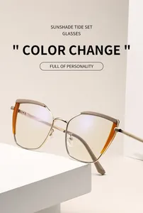 Detail of light gold cat-eye metal frame with orange accents and color-changing lenses