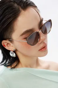 Fashion cat-eye sunglasses with tortoiseshell frames and gradient lenses on a female model