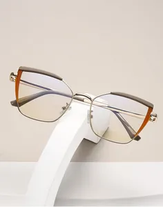 Detailed view of cat-eye glasses frame featuring amber accents and gold metal temples