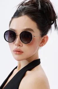Close-up of retro round polarized sunglasses with black frames and gold metal temples
