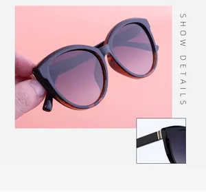 Detailed view of cat-eye sunglasses featuring tortoise temples and gold metal accents