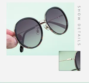 Detail view of round polarized sunglasses featuring tortoiseshell frame and metal hinges