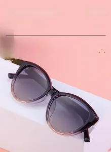 Detail view of cat eye sunglasses with purple gradient lenses and TR frames