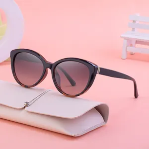 Chic women's cat eye sunglasses with leopard print frames and gradient lenses on pink props