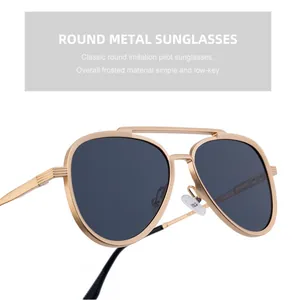 Detail of matte gold metal frame aviator sunglasses with classic double bridge design