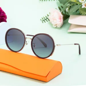 Women's round polarized sunglasses with gradient lenses and stylish orange eyewear case
