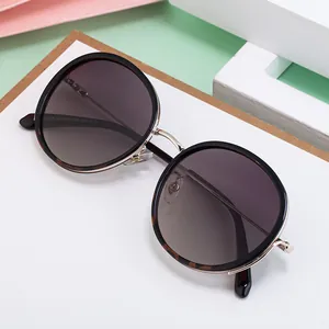 Chic women's round polarized sunglasses with black gold frames and gradient lenses