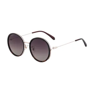 Fashionable round polarized sunglasses with tortoise shell accents and golden metal temples