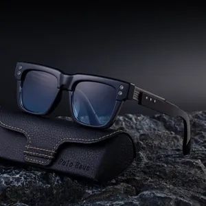 Chic square black sunglasses with blue reflective lenses and leather case on rock