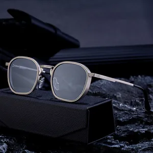 Classic square metal sunglasses with dark lenses and textured gold frames on a black case