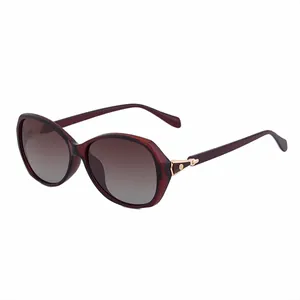 Occhiali da sole polarizzati da donna con montatura bordeaux e dettagli in metallo dorato