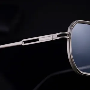 Macro shot of durable metal hinges and geometric hollow temples on square sunglasses