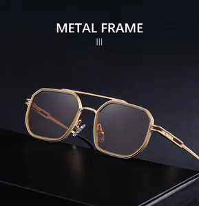 Detail of gold metal double-bridge sunglasses with hollow carved temples on black leather