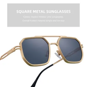 Detail view of square gold frosted metal frame and dark gray lenses for men sunglasses