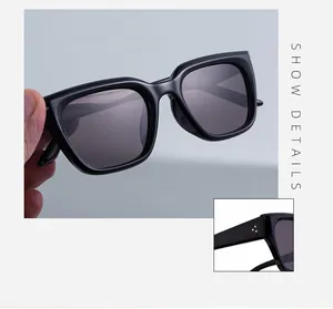 Détails de lunettes de soleil carrées noires avec rivets métalliques sur les branches