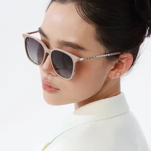 Detail view of square sunglasses with silver metal chain arms and pearl embellishments