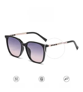 Detail view of gold chain temple with black beads on square gradient sunglasses