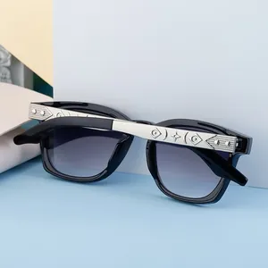 Detail of square sunglasses with silver star pattern engraving on black temples