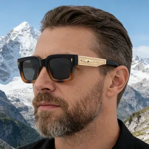 Detail of square sunglasses with gold engraved temples and green jewel accent for men