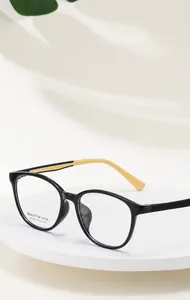 Detailed close-up of retro square black and yellow eyeglass frames with model KT62601