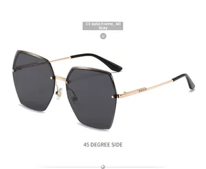 Detail of C3 gold frame sunglasses with diamond-cut grey rimless polygon lenses