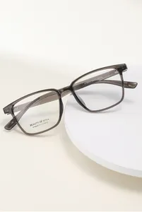 Detail view of large grey transparent eyeglass frames showing model specs AT68600 C2