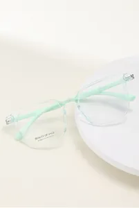Detail view of transparent mint green square optical glasses frame with metal hinges