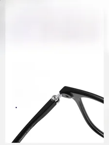 Detailed macro view of durable metal hinges and model AT68622 on black optical frames