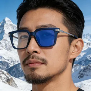 Close-up of stylish blue square sunglasses with metal temples on a snowy mountain