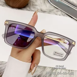 Detail of square photochromic glasses with sand gray matte frame and metal trim