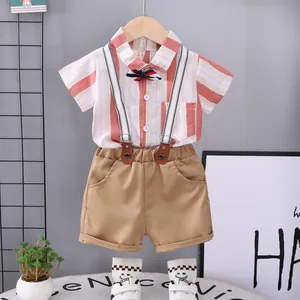 Boys summer cotton set with red striped short-sleeve shirt, bowtie, and khaki suspender shorts