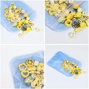 Detailed view of yellow ceramic DIY beads set in translucent blue resealable pouch