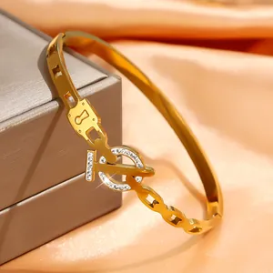 Polished 18k gold plated stainless steel bangle with crystal pave lock and key design
