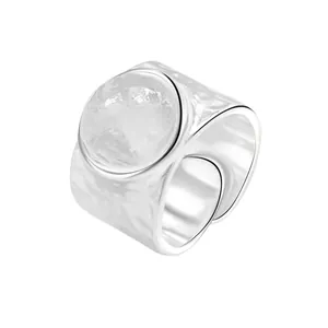 Irregular textured silver open ring with round crystal dome in a modern minimalist style