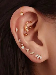 Detailed view of s925 gold opal earrings set worn on ear featuring flat back studs