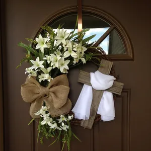 Easter wreath with cross white lilies and burlap bow on brown front door decor