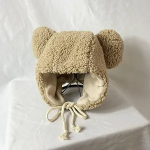 Close-up of khaki plush winter hat with cute bear ears and soft fleece lining for warmth