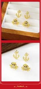 Detail of gold anchor and crab stud earrings set with sparkling micro-pave zirconia