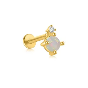 Close-up of gold s925 silver labret earring with round opal and sparkling zircon stone