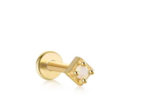 Macro detail of gold S925 silver flat back stud with four-prong set white opal gemstone