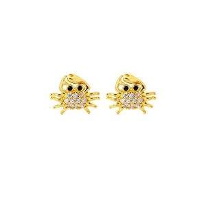 Gold plated crab stud earrings with white zircon accents and black stone eyes