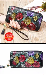 Macro detail of 3D embossed colorful rose patterns on premium leather zip wallet